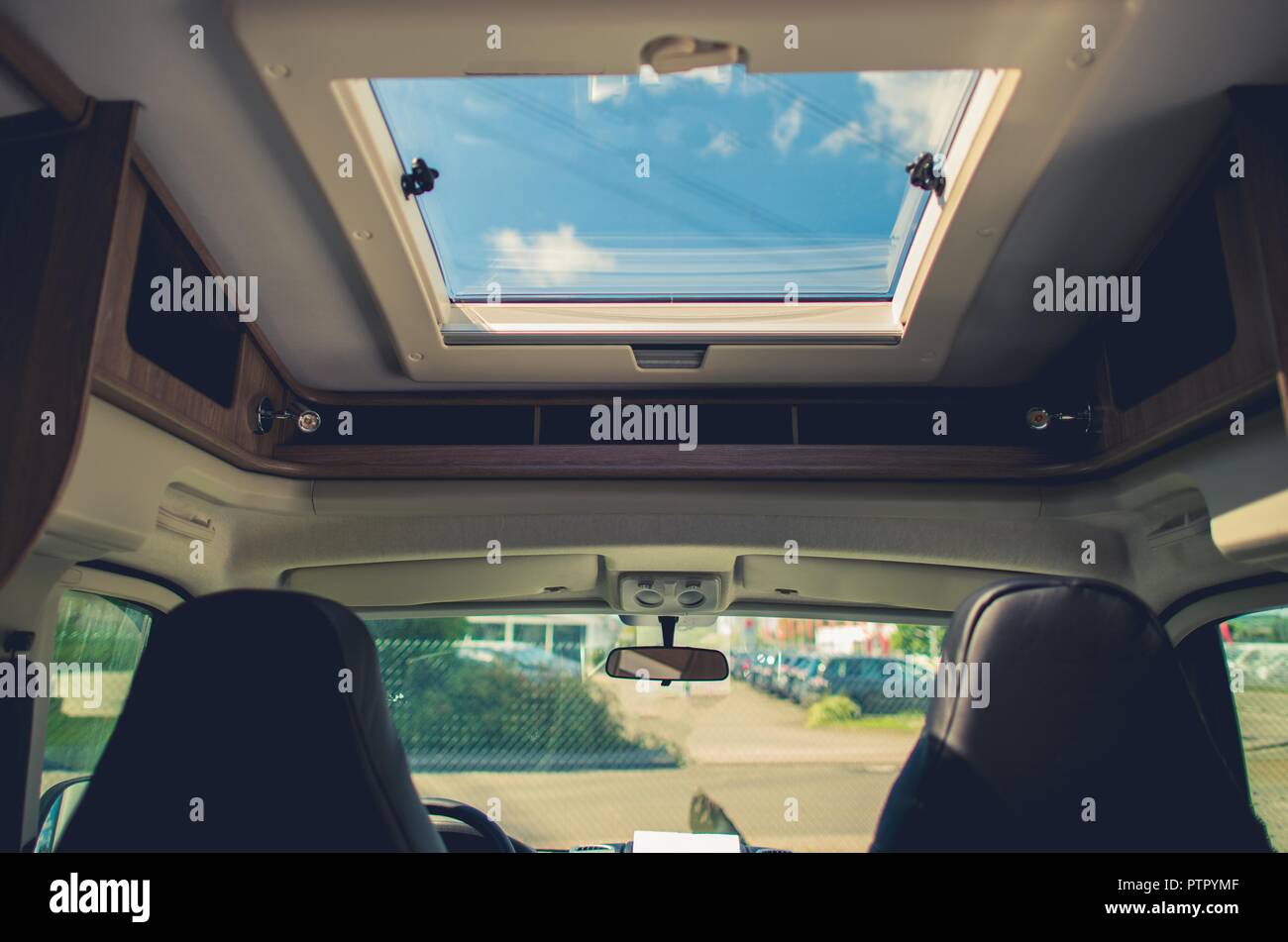 RV Camper Van Road Trip. Motorhome Front Interior with Large Skylight