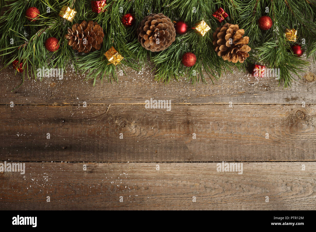 Christmas card on wooden background with snow fir tree, pine cones and ...