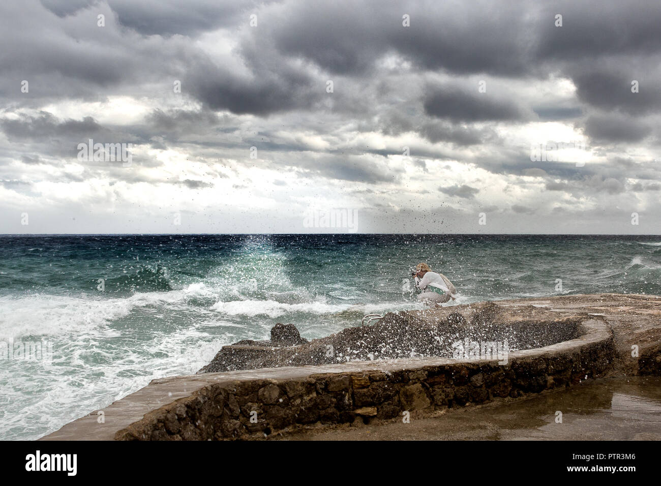 Europe Spain Mallorca - strong storm in the east, high waves hit the coast, photographer photographs the strong storm Stock Photo