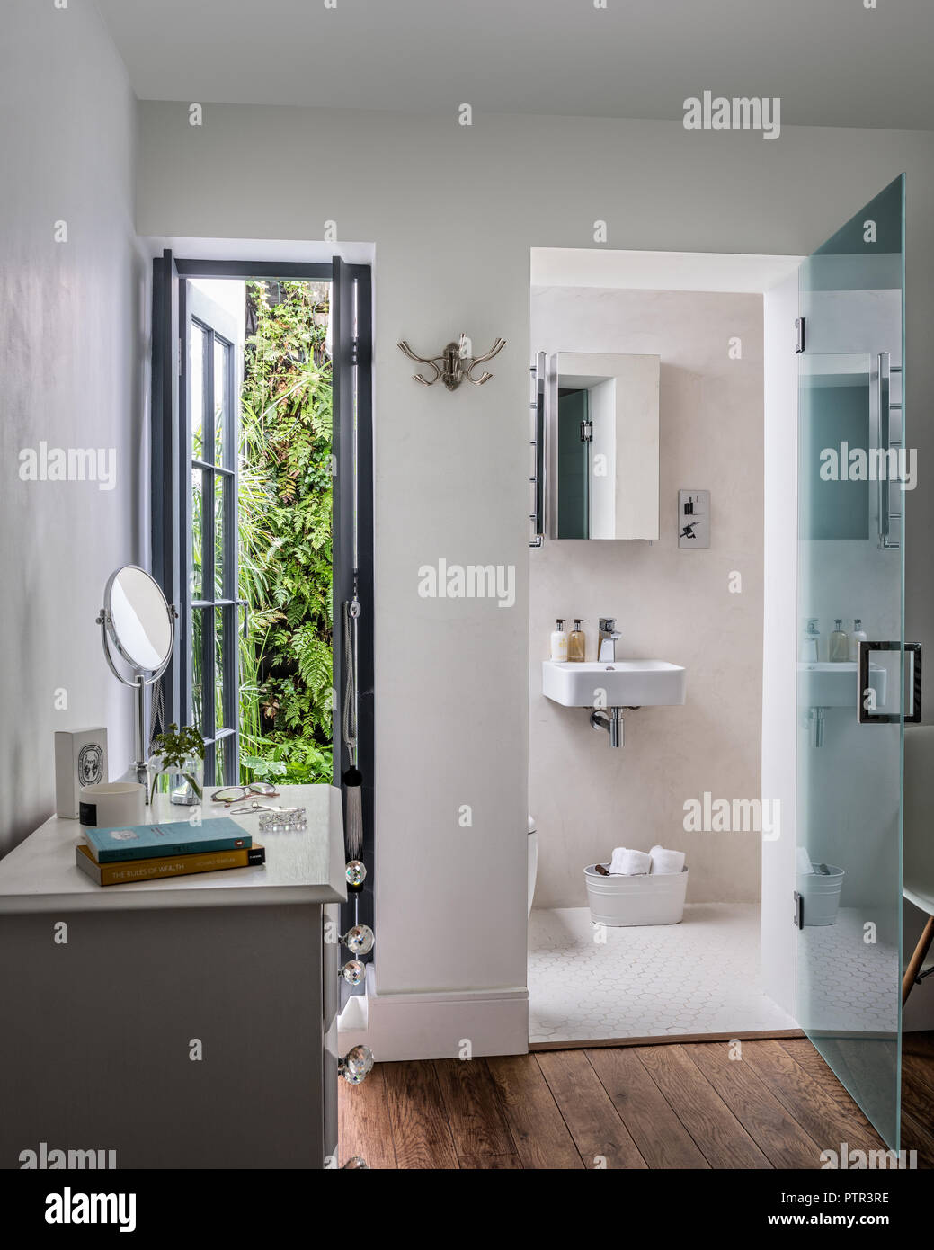 Ensuite bathroom with mirrored cabinet and frosted glass door Stock Photo