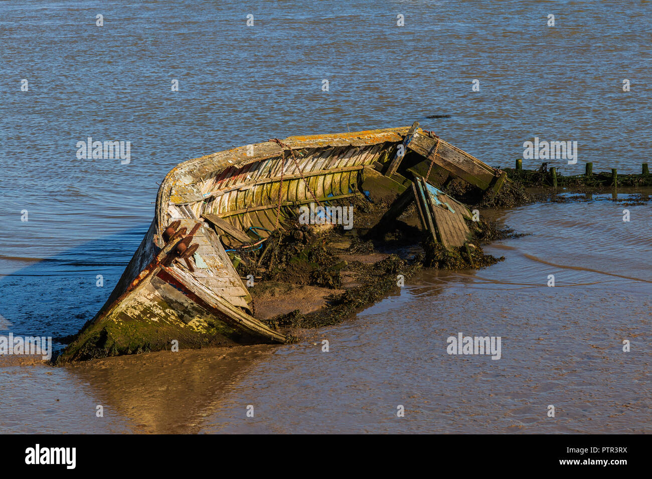 An Abandoned and Derelict Old Sailing Boat at Orford in Suffolk Stock Photo