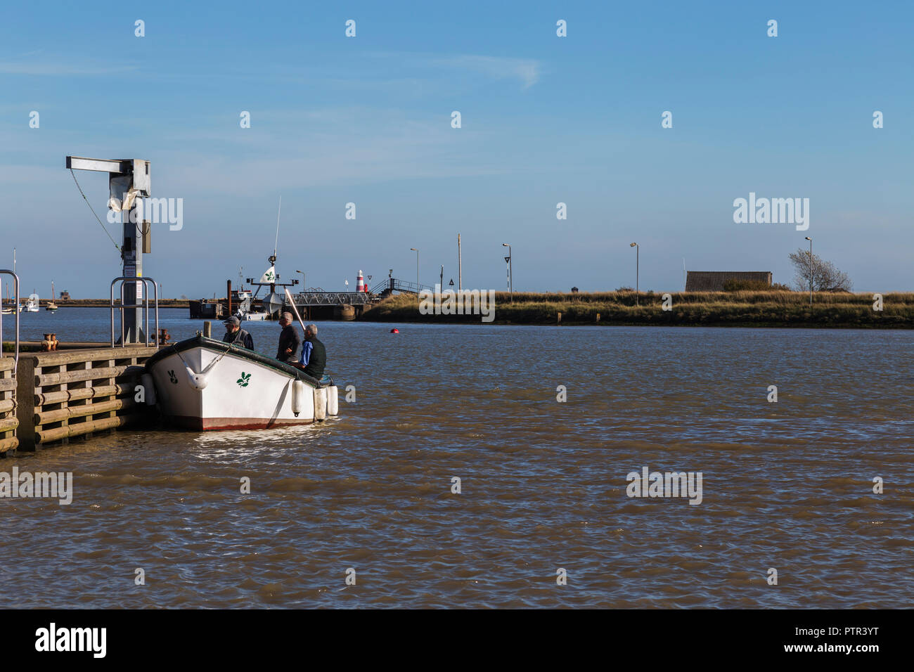Small Ferry Alongside Quay at Orford before Crossing River Ore to Orford Ness Stock Photo
