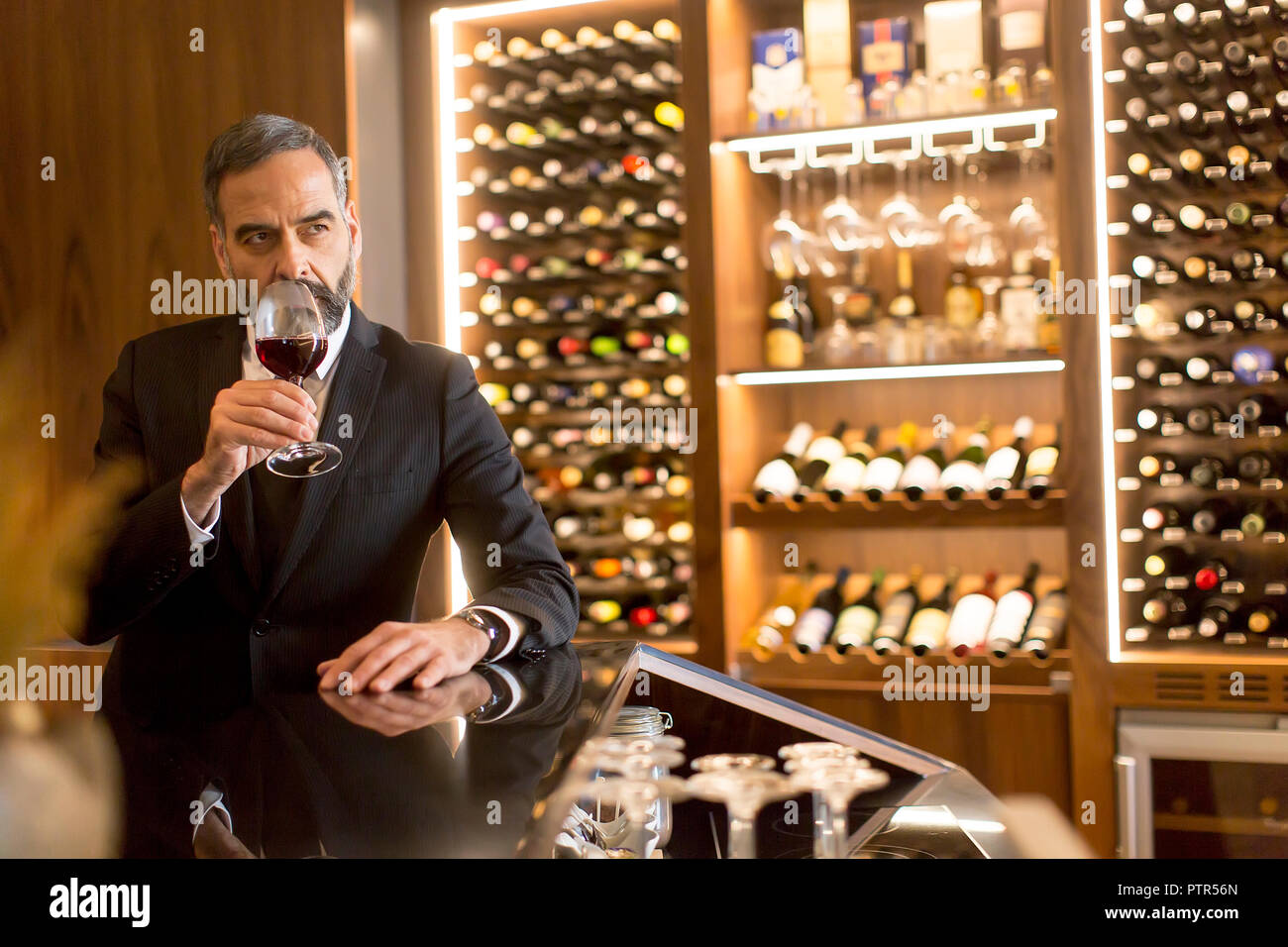 Portrait of senior handsome man drinking red wine Stock Photo - Alamy