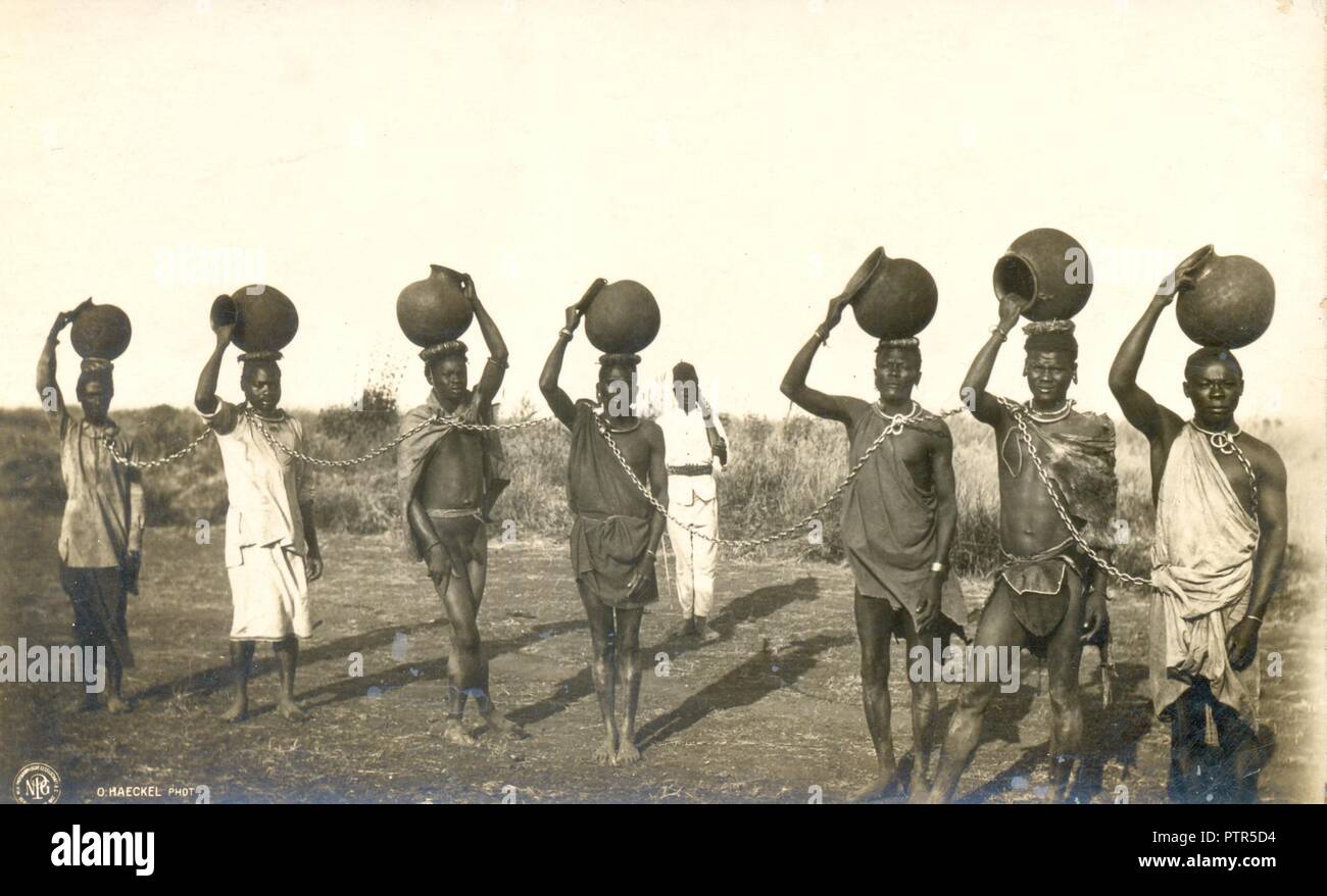 Photograph of seven prisoners in chain gang in German East Africa circa 1905 Stock Photo