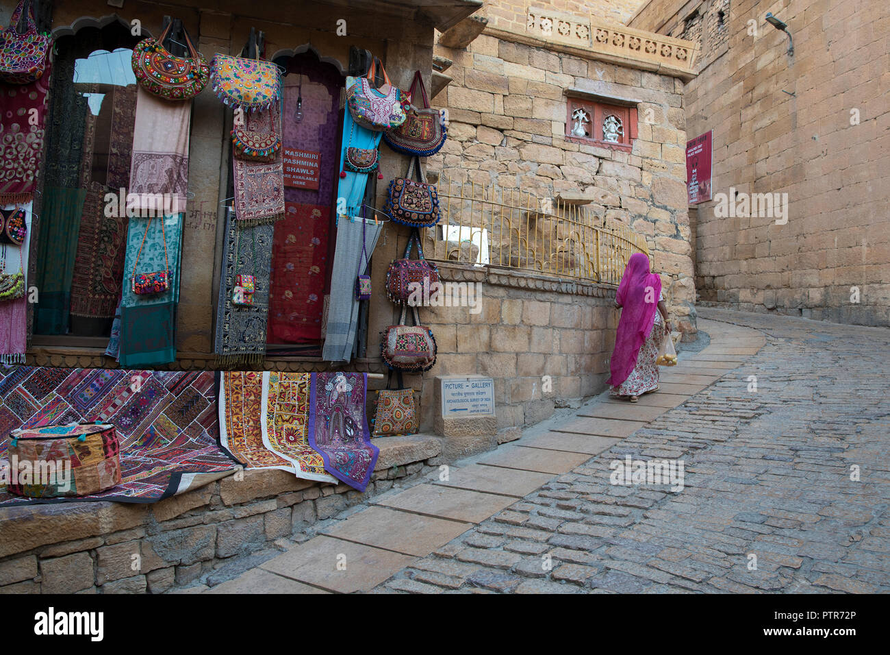 The image of Rajasthani traditional lady waliking in jaisalmer fort, Jaisalmer, Rajasthan, India Stock Photo