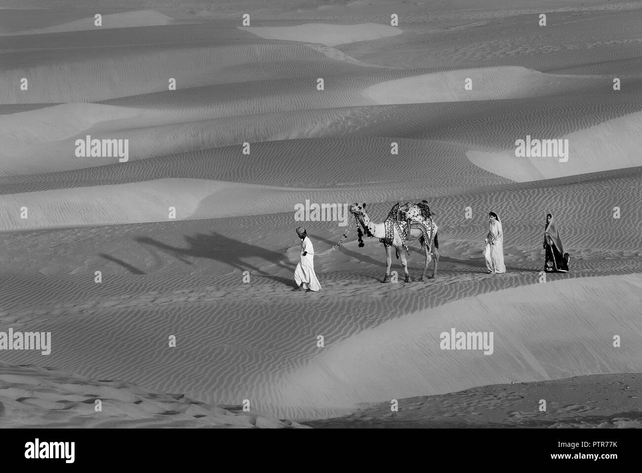The image of Rajasthani traditional people in sand dunes of  Jaisalmer, Rajasthan, India Stock Photo