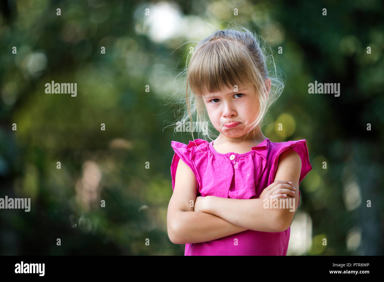 Portrait Of Pretty Funny Moody Unhappy Young Blond Child Girl In