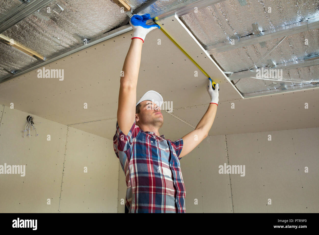 Young Handsome Man In Casual Clothing Takes Measurement Of