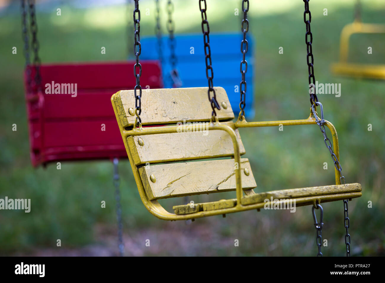 Close Up Of Empty Wooden Painted Blue Yellow Vintage Seats