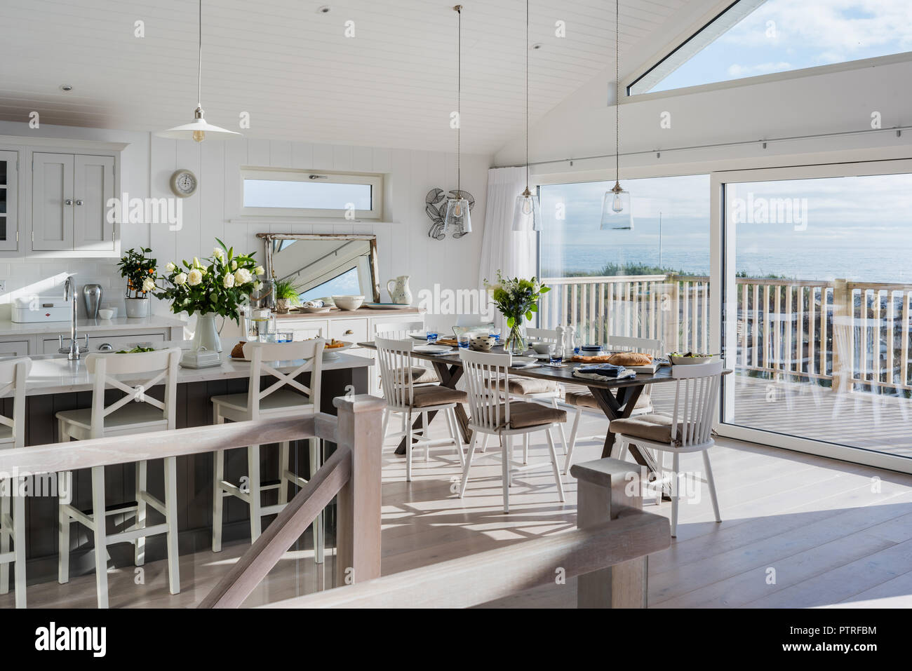 Open plan kitchen and dining room with sea views Stock Photo