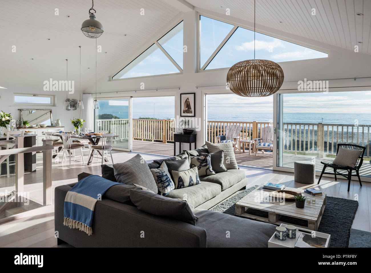 Open plan living room with view to sea Stock Photo
