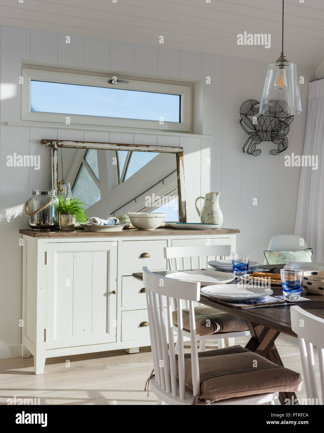 Open Plan Kitchen And Dining Room With Sea Views Shaker Style Sideboard And Mirror With Dining Table In Coastal Home Stock Photo Alamy