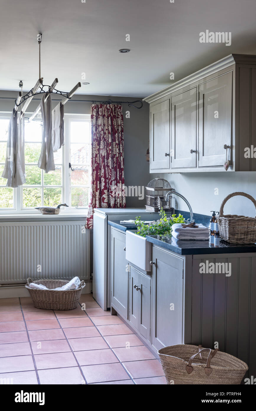 Laundry airer and butler sink in utility room of restored 16th century farmhouse Stock Photo