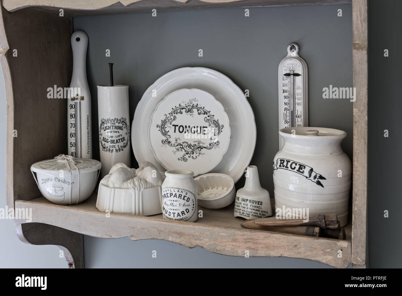 16th century farmhouse renovation Antique kitchenware on wall mounted shelf in restored 16th century farmhouse Stock Photo