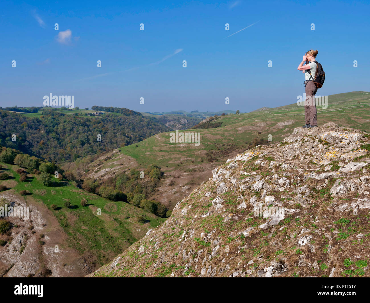 Peak District National Park, Derbyshire, UK. 10th October, 2018. UK Weather woman admiring the view on the top of Thorpe Cloud on a unusually hot sunny October day in the tourist hotspot of Dovedale in the Peak District National Park, Derbyshire Credit: Doug Blane/Alamy Live News Stock Photo