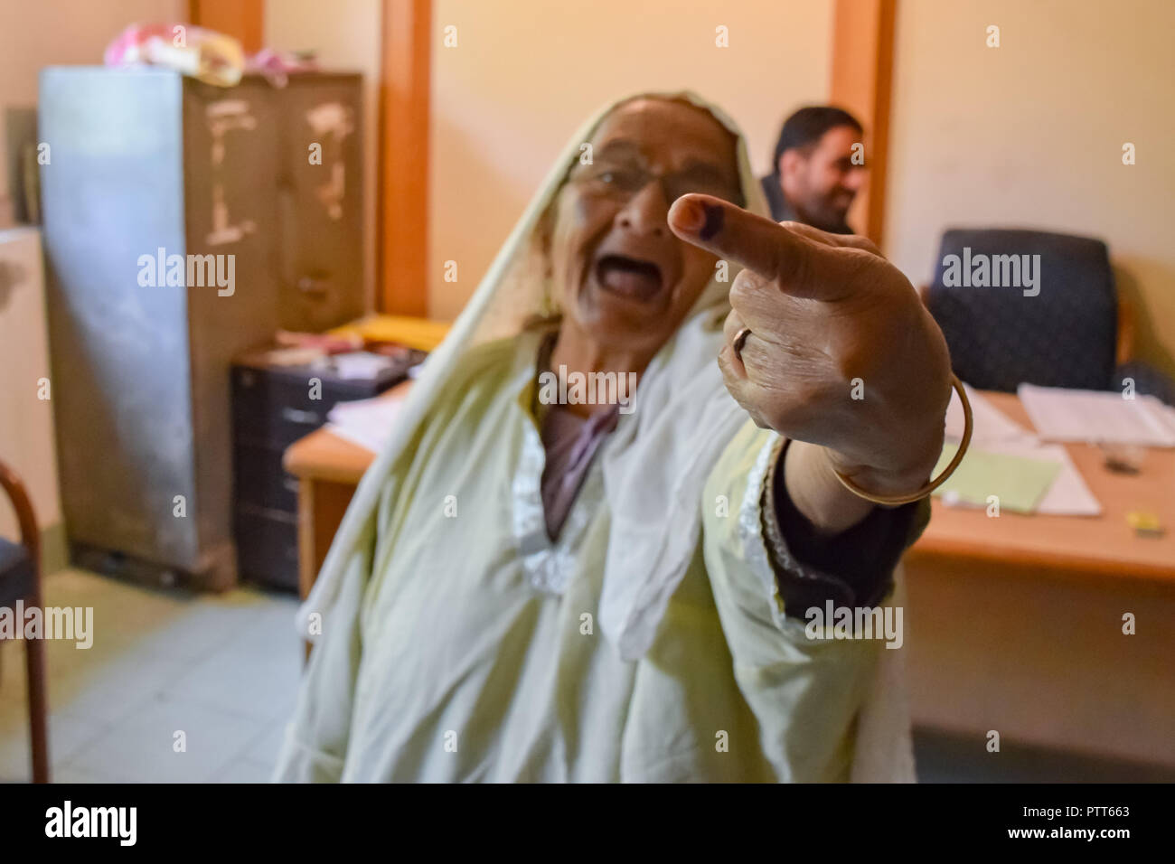 October 10, 2018 - Srinagar, Jammu & Kashmir, India - An elderly woman seen showing her ink marked finger after casting her vote during elections..Second phase of urban local body (ULB) Elections held in Jammu and Kashmir. Summer Capital of Indian controlled Kashmir, Srinagar. This had the lowest turnover of voters during the Local elections. (Credit Image: © Idrees Abbas/SOPA Images via ZUMA Wire) Stock Photo