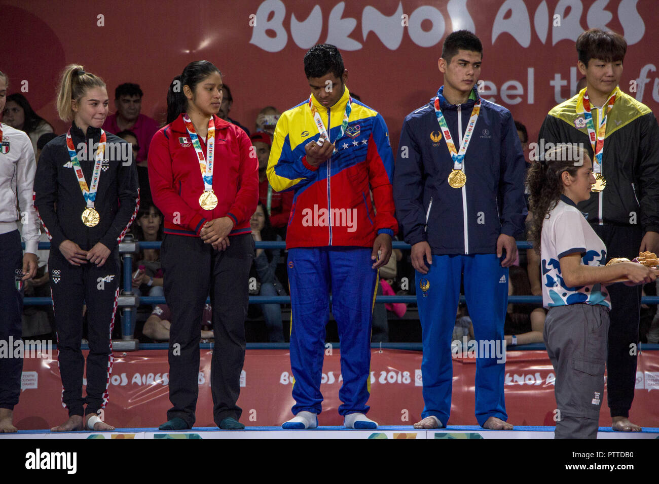 Buenos Aires, Buenos Aires, Argentina. 10th Oct, 2018. The fourth and final day of judo in Buenos Aires 2018 had mixed team competition, where boys and girls from different countries and continents competed as teams.The Beijing team consisting of Artsiom Kolasau (Belarus), Li Ling Liu (China Taipei), Jaykhunbek Nazarov (Uzbekistan), Carlos PÃ¡ez (Venezuela), Itzel Pecha (Mexico), Ana Viktorija Puljiz (Croatia) and VerÃ³nica Toniolo (Italy) were the members of the team that climbed to the top of the podium and received the gold medals on the tatami.Team competitions are promoted in the yo Stock Photo