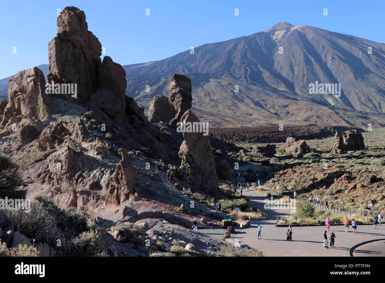 At the viewpoint Mirador Roques de Garcia on the way to the Pico del Teide on the Canary Island Tenerife on 18.09.2018. The rock formation Roques de Garcia is located about five kilometers south of the summit of Teide at an altitude of about 2200 m at the edge of the extensive Caldera Las Ca-adas. The area is part of the Teide National Park (Parque Nacional del Teide). The Pico del Teide (also Teyde) is with 3718 m the highest elevation on the Canary Island of Tenerife and the highest mountain in Spain. It belongs to the municipality of La Orotava. In 2007, the territory of the National Park w Stock Photo