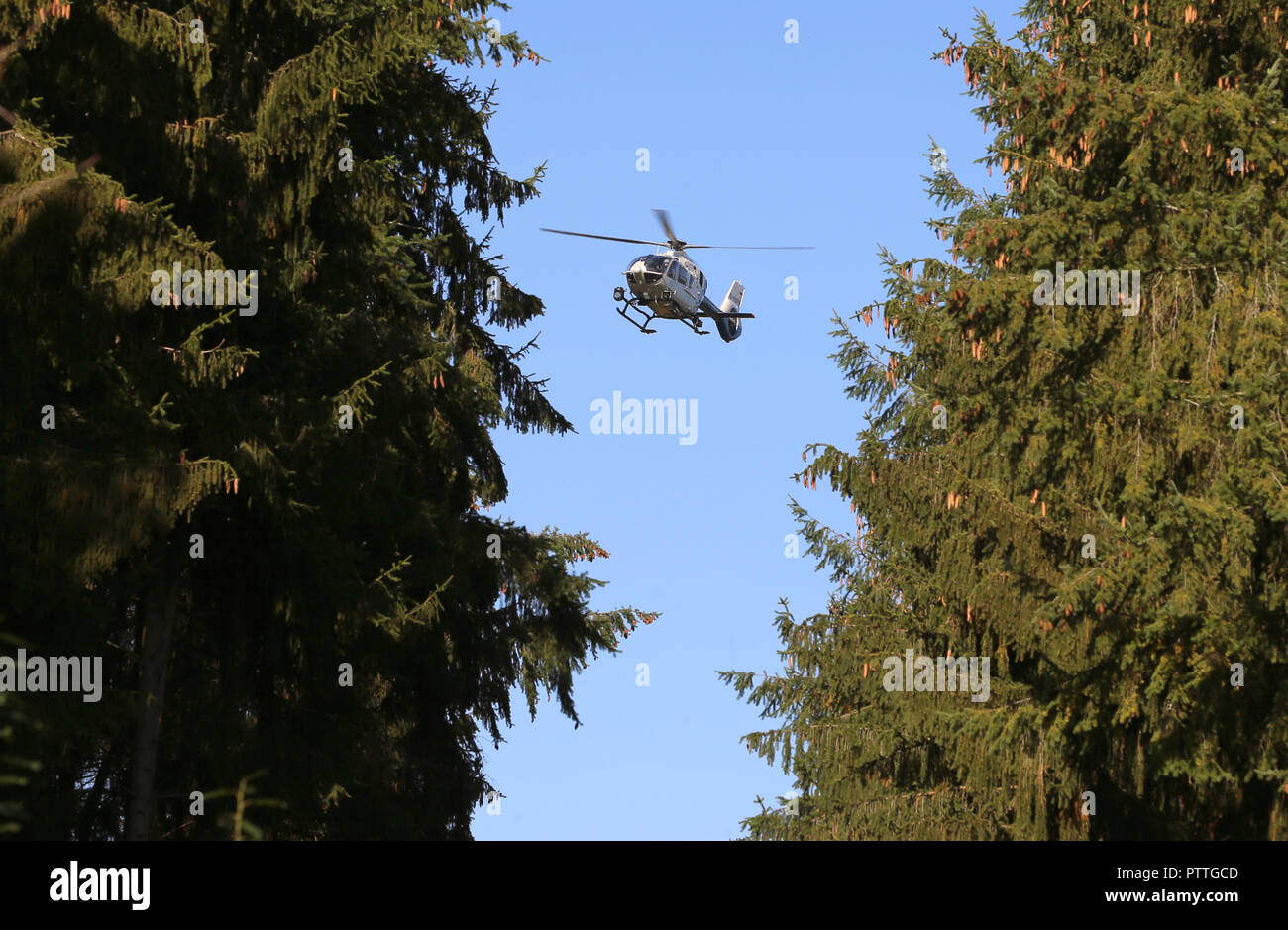 Burgsinn, Bavaria. 11th Oct, 2018. A police helicopter is circling over a piece of woodland. In connection with the disappearance of a four-time mother thirteen years ago, police searched a forest area in Lower Franconia on Thursday morning. Credit: Karl-Josef Hildenbrand/dpa/Alamy Live News Stock Photo
