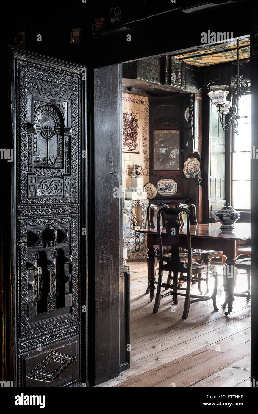 Carved oak panels frame doorway to dining room in Hauteville House Stock Photo