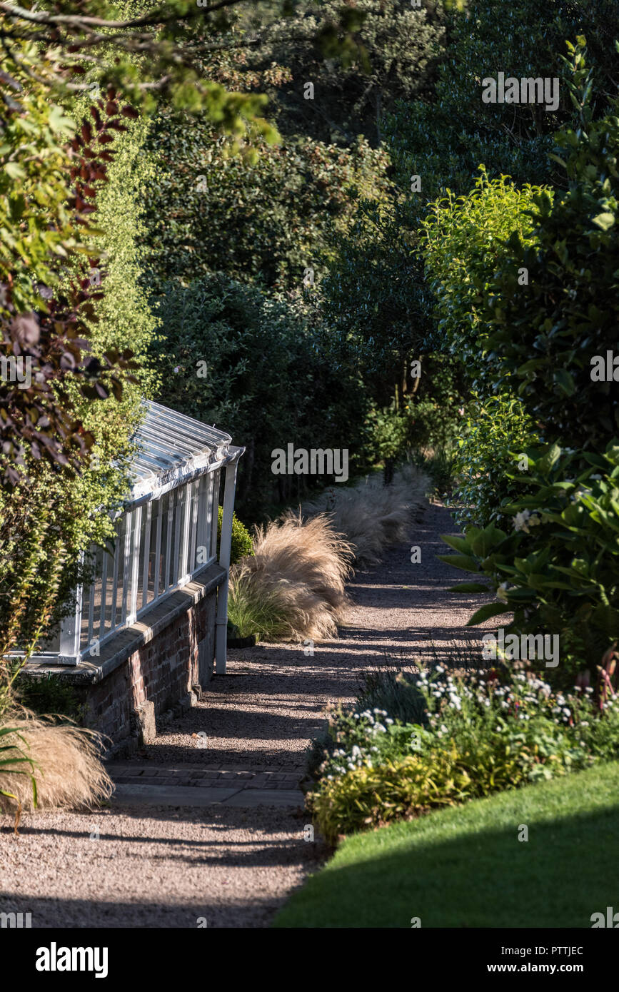 Glasshouse and gravel path in garden of Hauteville House Stock Photo