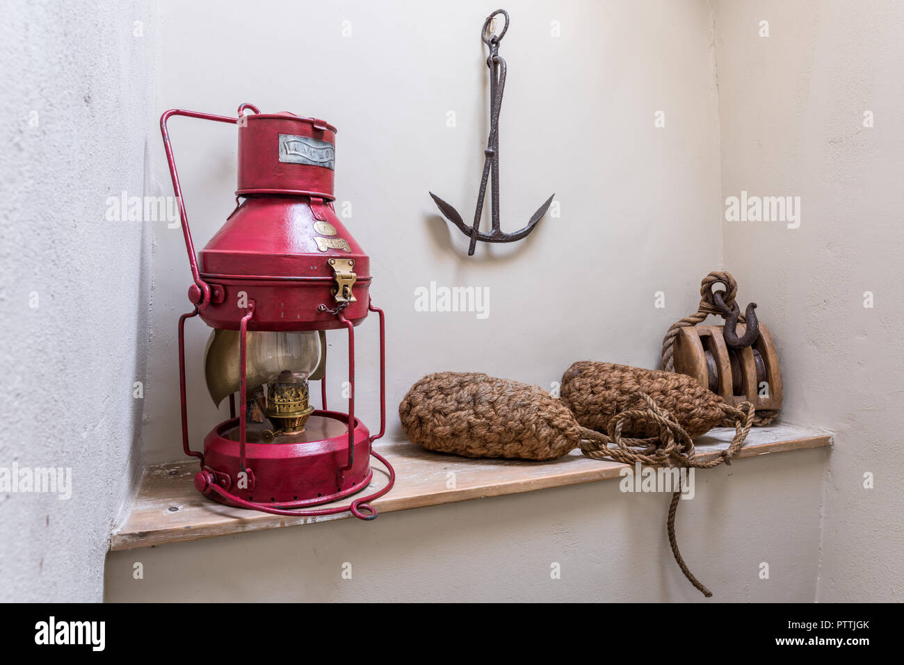 Red oil lamp with rope buoys, winch and anchor Stock Photo