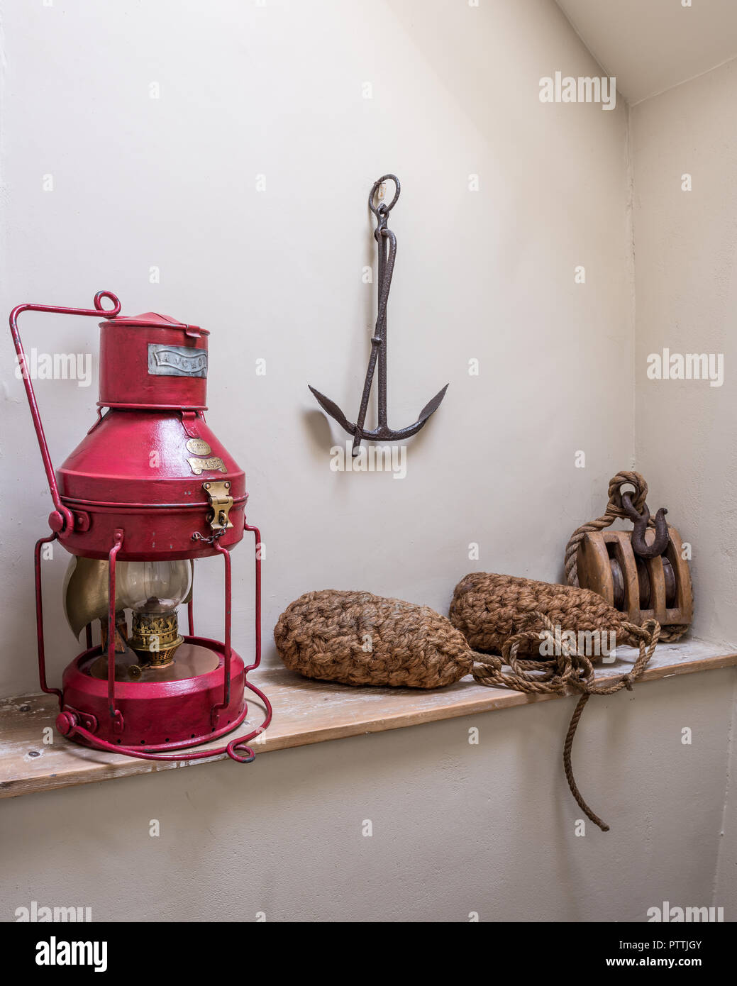 Red oil lamp with rope buoys, winch and anchor Stock Photo