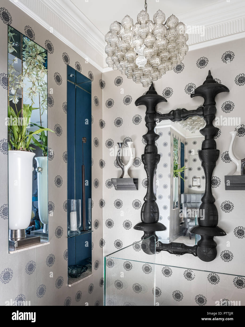 Black mirror frame and patterned wallpaper with mirror and pendant light Stock Photo