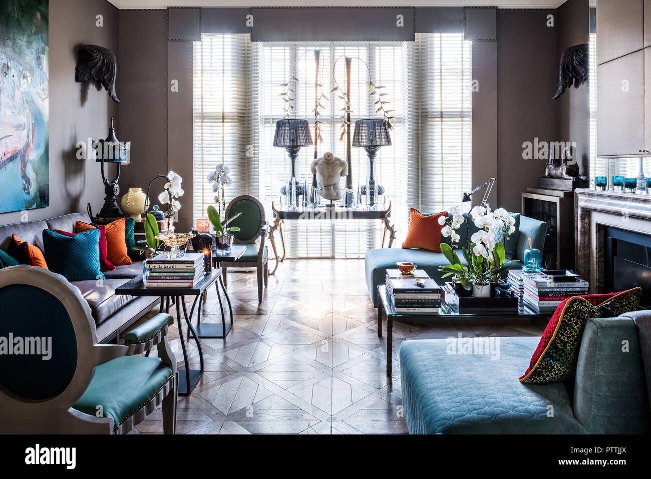 Daybeds designed by Stephen Ryan with lamps on table in window Stock Photo