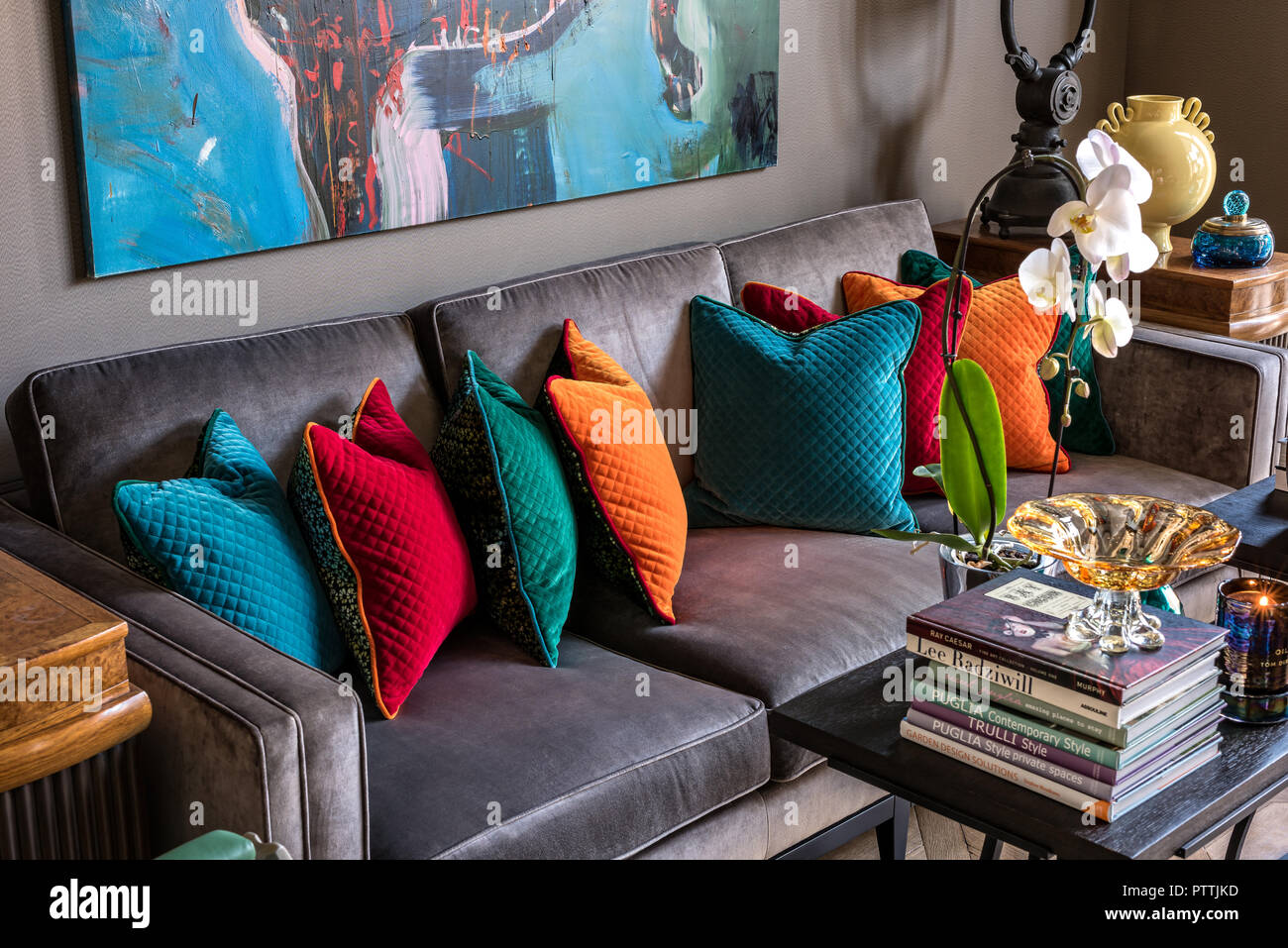 https://c8.alamy.com/comp/PTTJKD/vibrant-artwork-by-nicolas-kuligowski-bergere-above-velvet-grey-sofa-with-cushions-PTTJKD.jpg