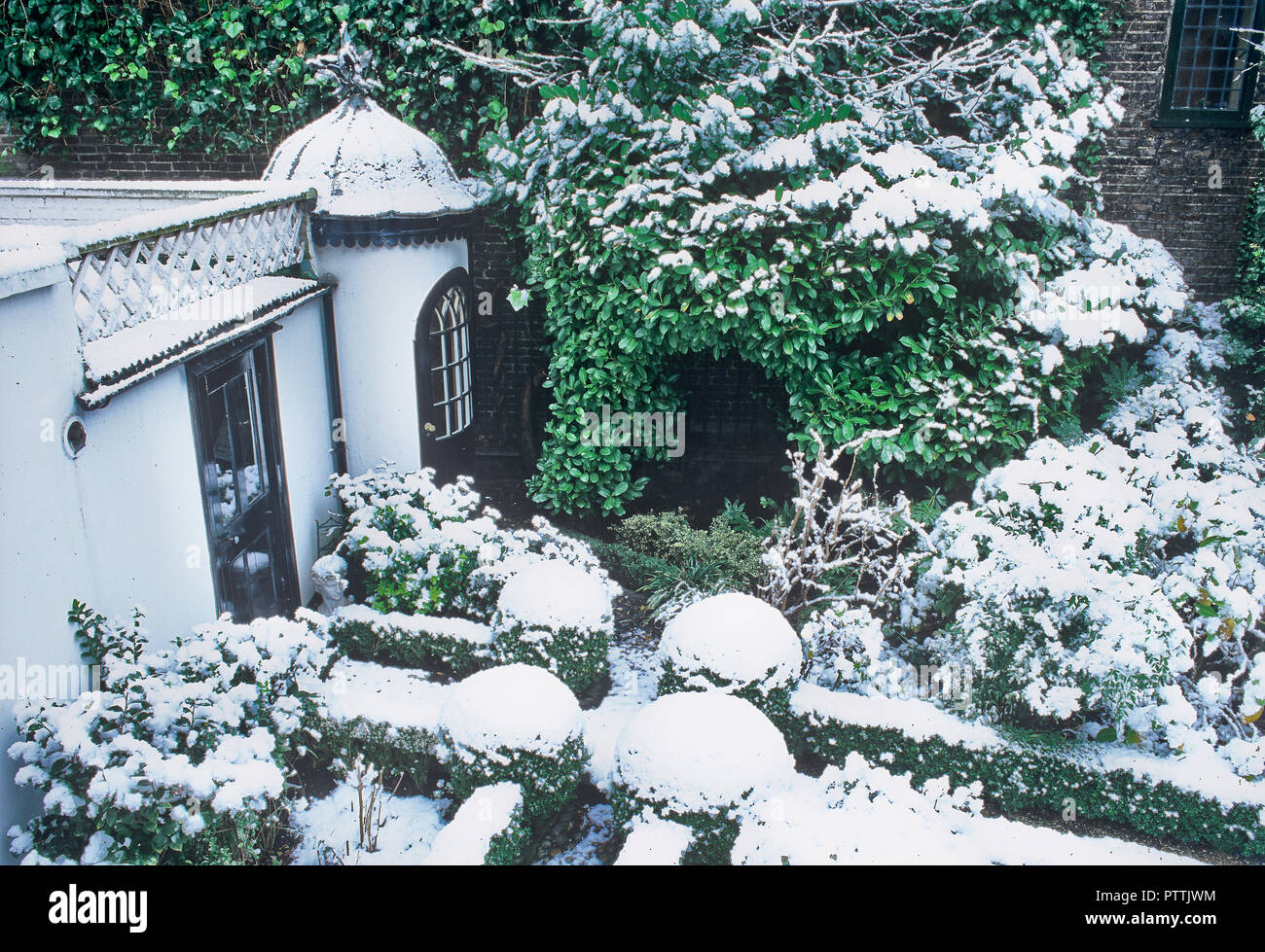 Victorian summerhouse and garden under snow Stock Photo