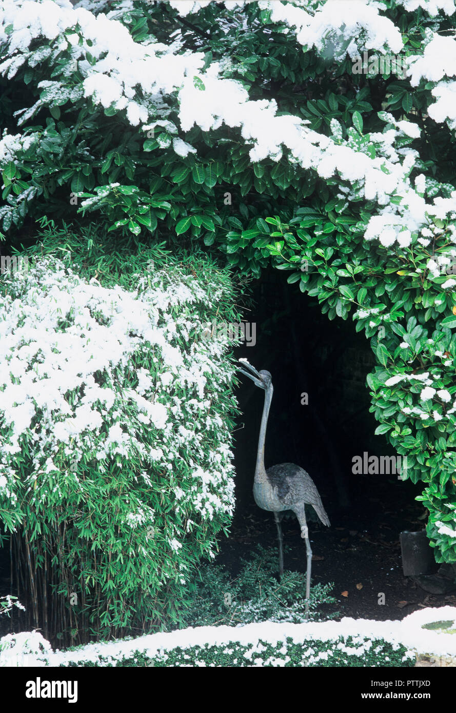 Bird statue sheltering in bower in Lord Snowdon's garden Stock Photo