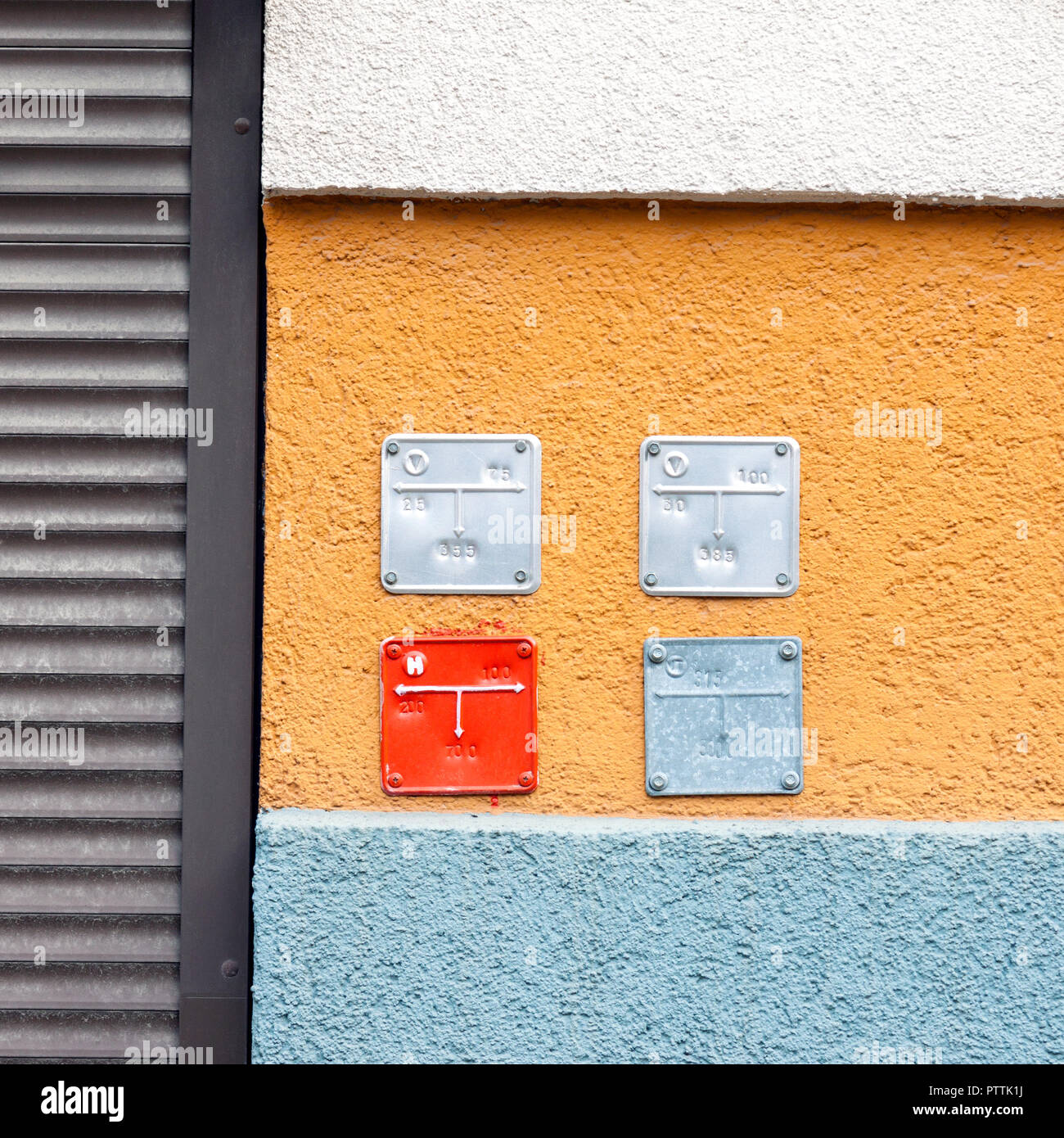 Colorful building wall with sign plates for natural gas pipes, abstract industrial architecture picture Stock Photo