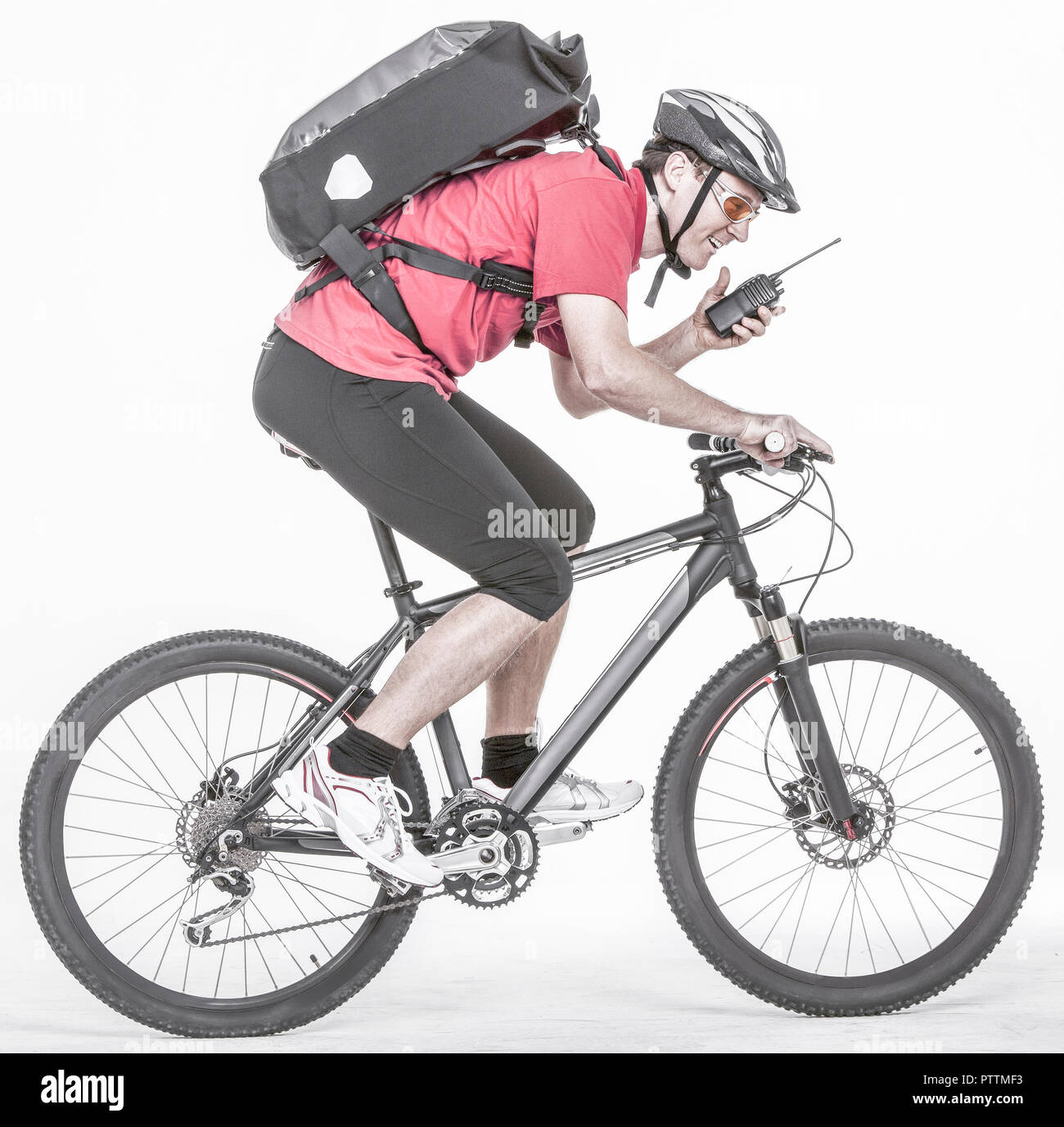 Fahrradkurier auf Rad mit Funkgeraet (model-released) Stock Photo