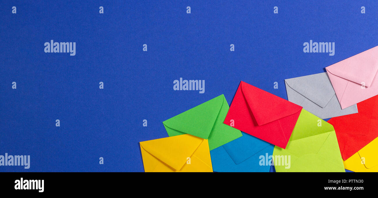 Colorful envelopes on blue background, top view Stock Photo