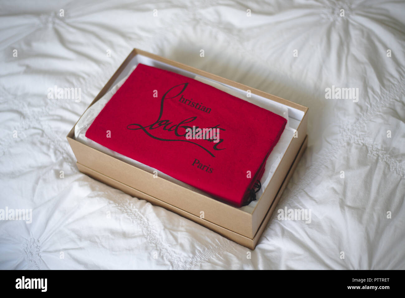 Christian Louboutin Shoes in a box on a white duvet Stock Photo