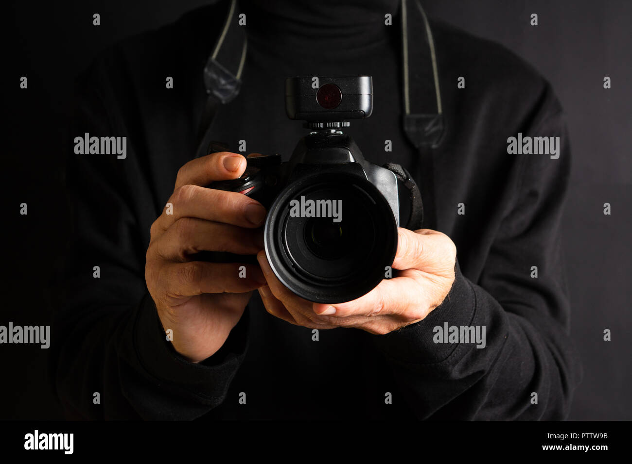Person holding a DSLR camera close up Stock Photo