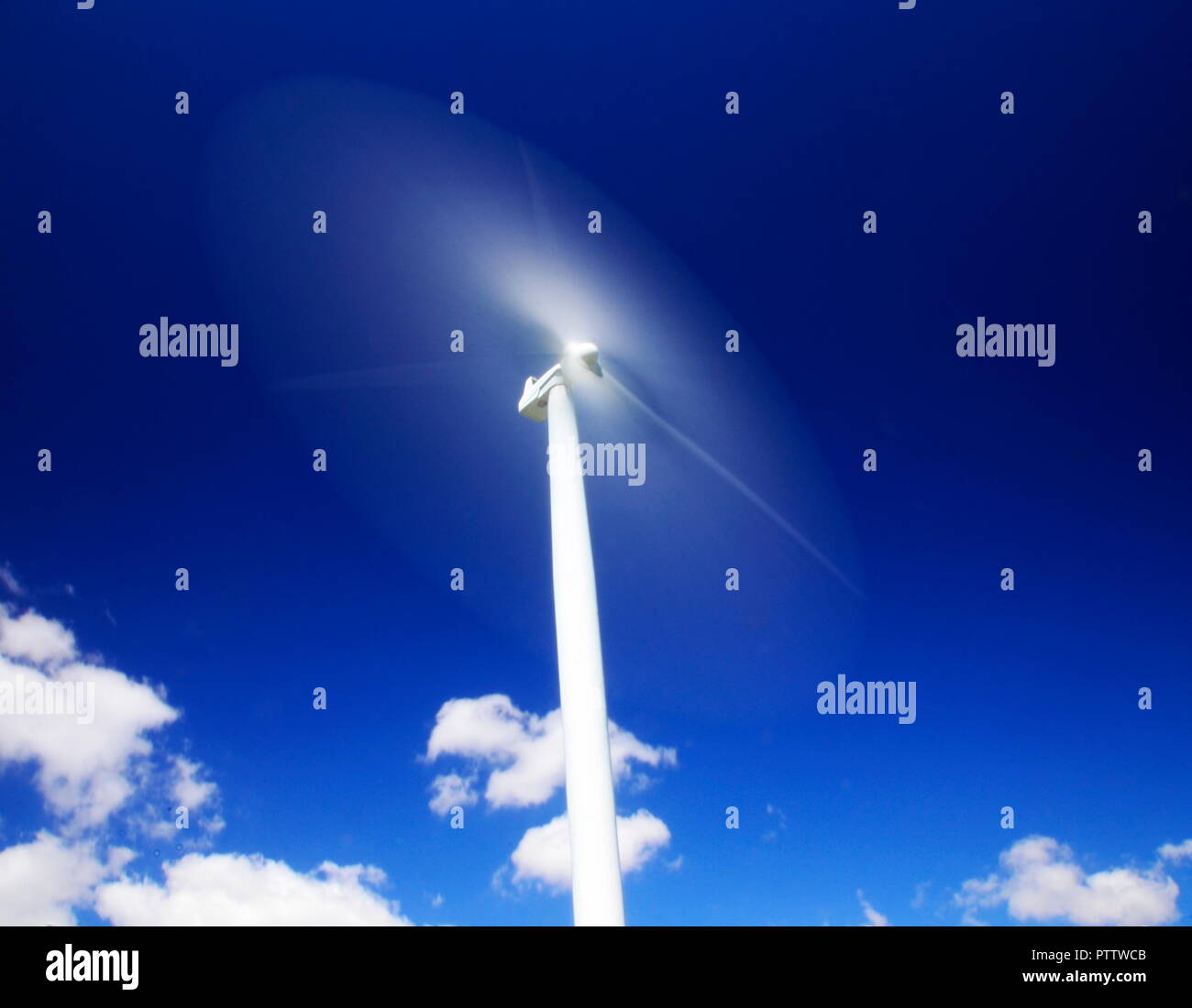 the metaphor of the future quickly approaching is the blades of a wind  turbine spinning faster than speed of light Stock Photo - Alamy