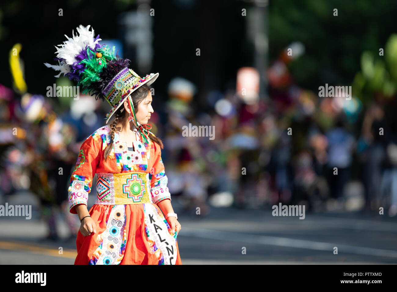 Washington, D.C., USA - September 29, 2018: The Fiesta DC Parade, Young Bolivian girl wearing traditional clothing going down the street during the pa Stock Photo
