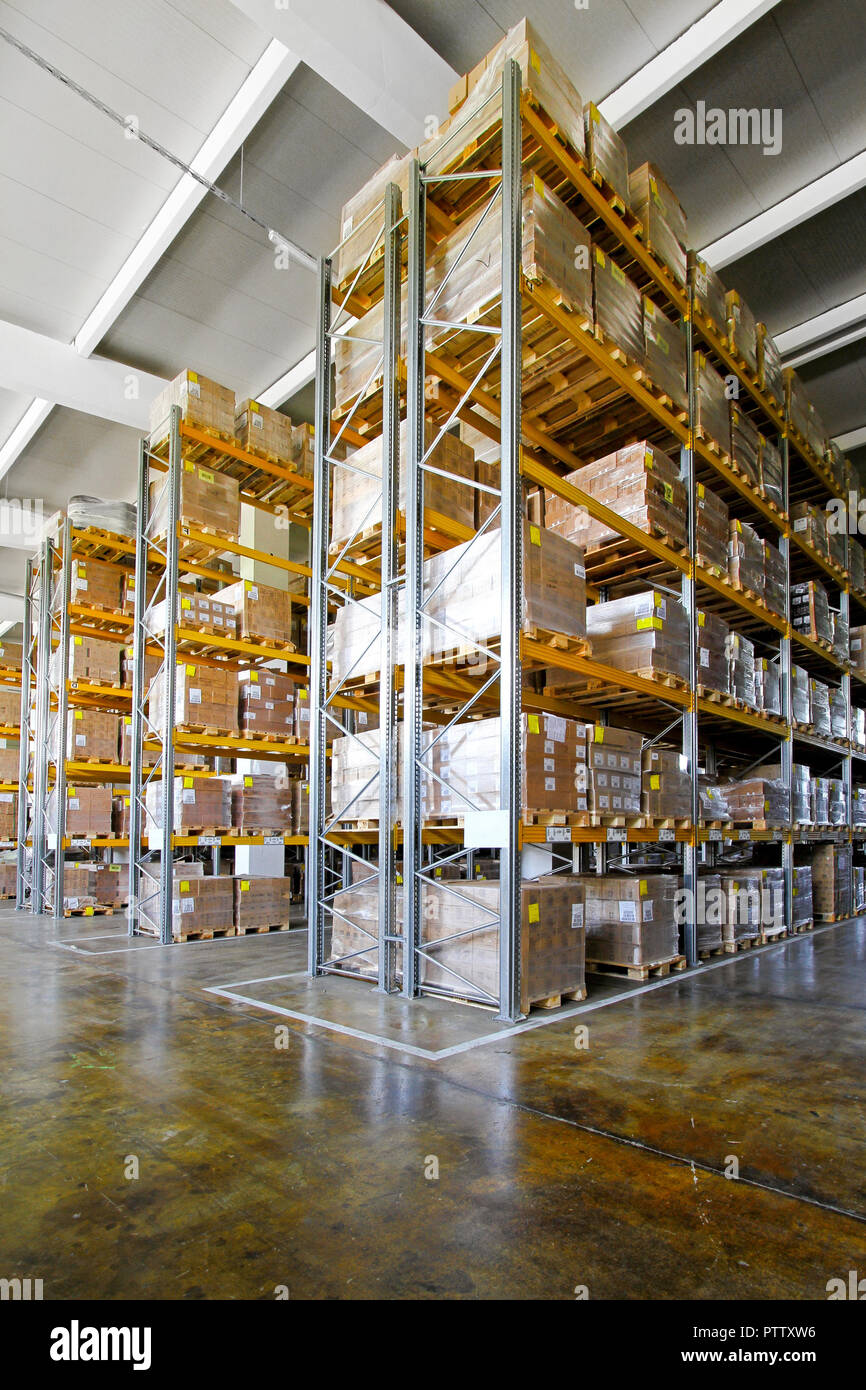 Tall shelves and racks in distribution warehouse Stock Photo - Alamy