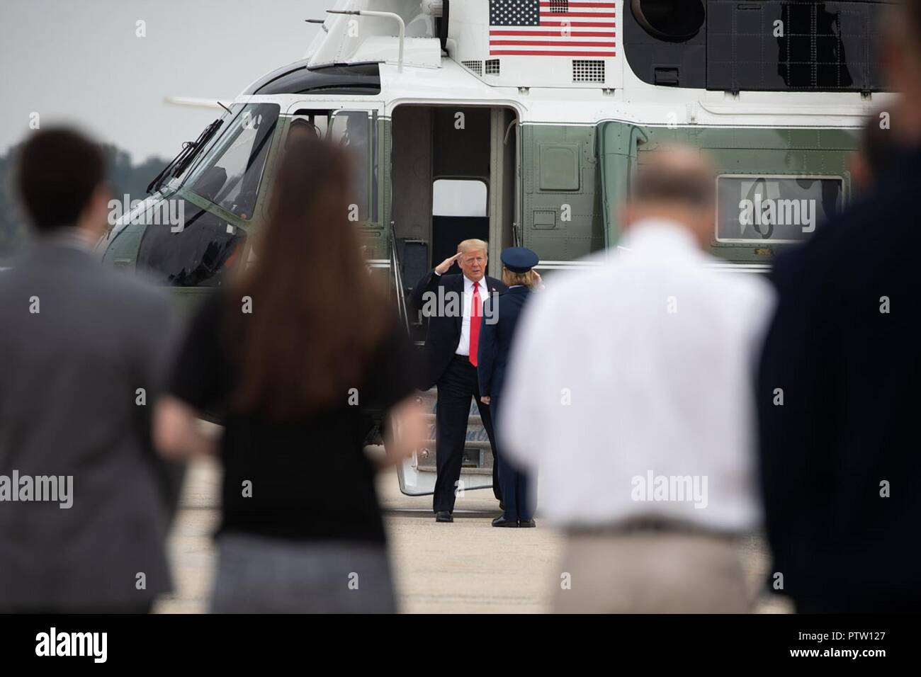 U.S President Donald Trump salutes as he disembarks Marine One on his way to address the International Association of Chiefs of Police and Law Enforcement Convention and campaign for GOP candidates in Florida October 8, 2018 at Joint Base Andrews, Maryland. Stock Photo