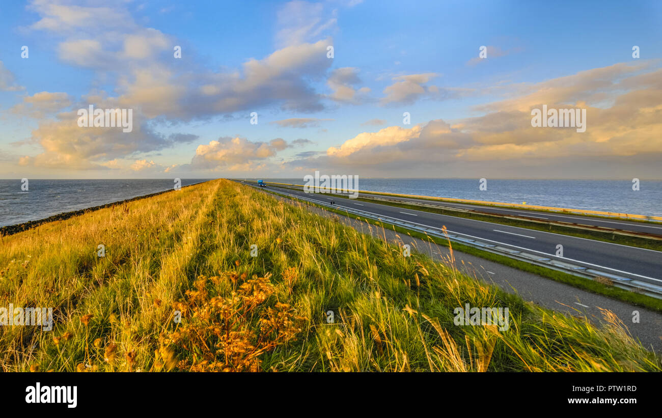 Beautiful sunset view at the Lake IJssel with fishing net poles in  Flevoland, the Netherlands Stock Photo - Alamy