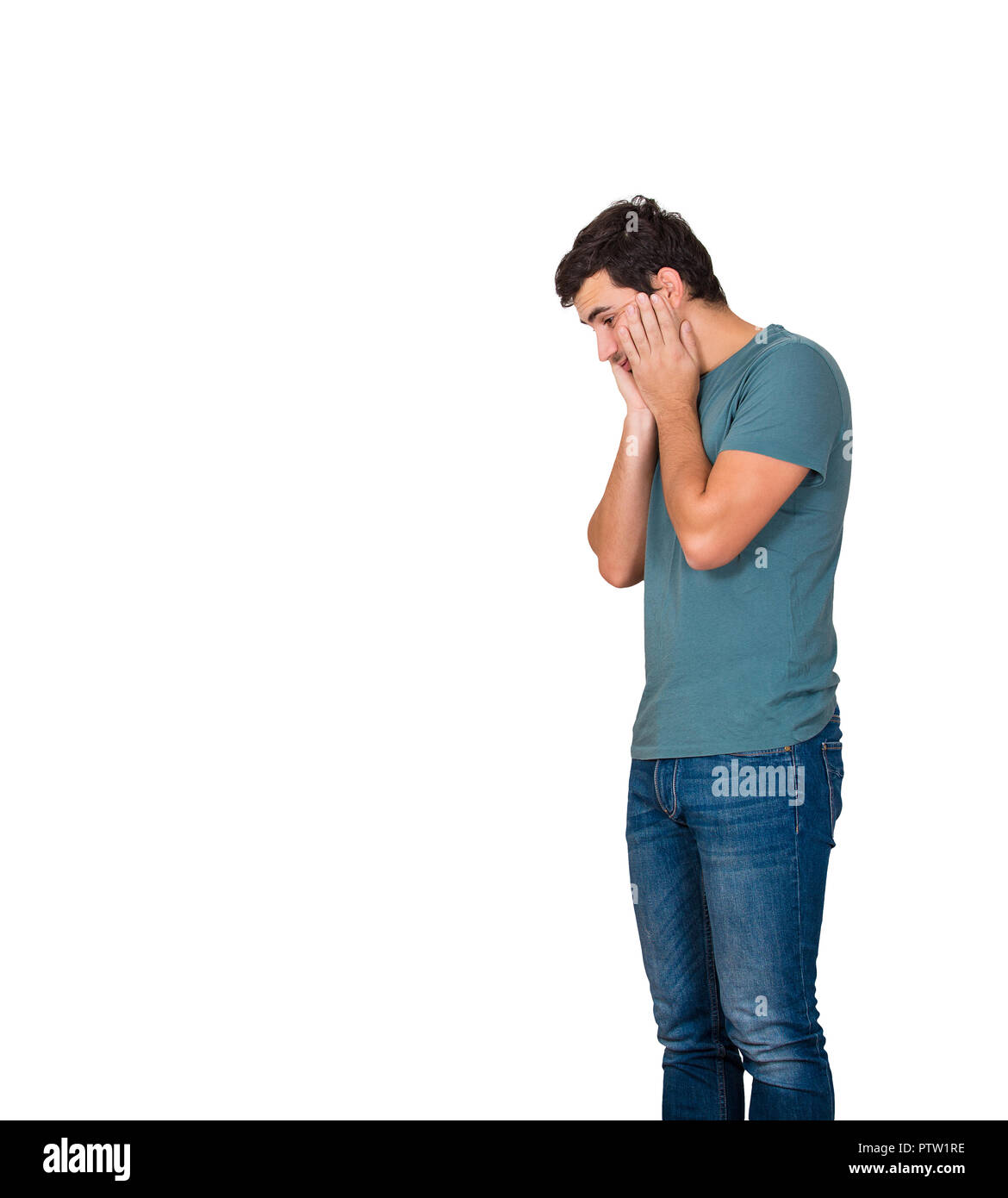 Profile view of sad young man looking down Stock Photo - Alamy