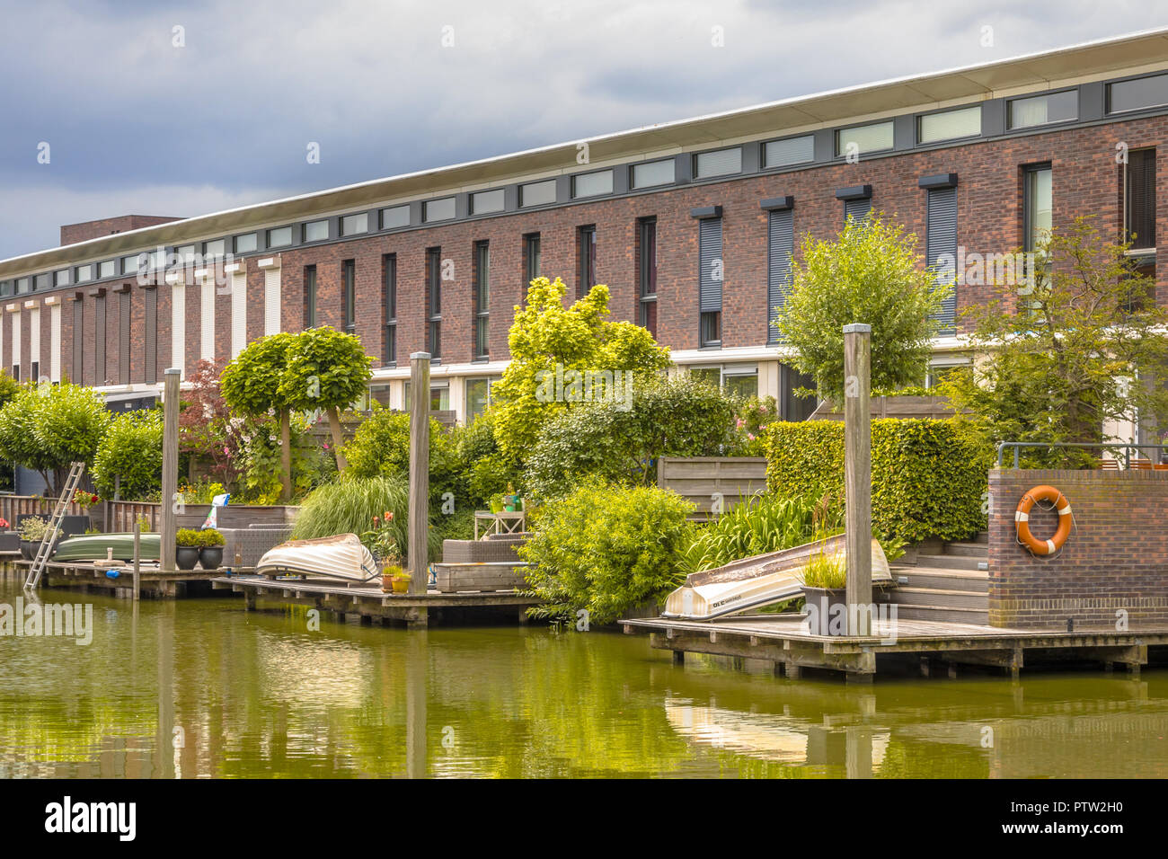 Modern row houses with  hanging terrace gardens on waterfront in urban area of The Hague, Netherlands Stock Photo