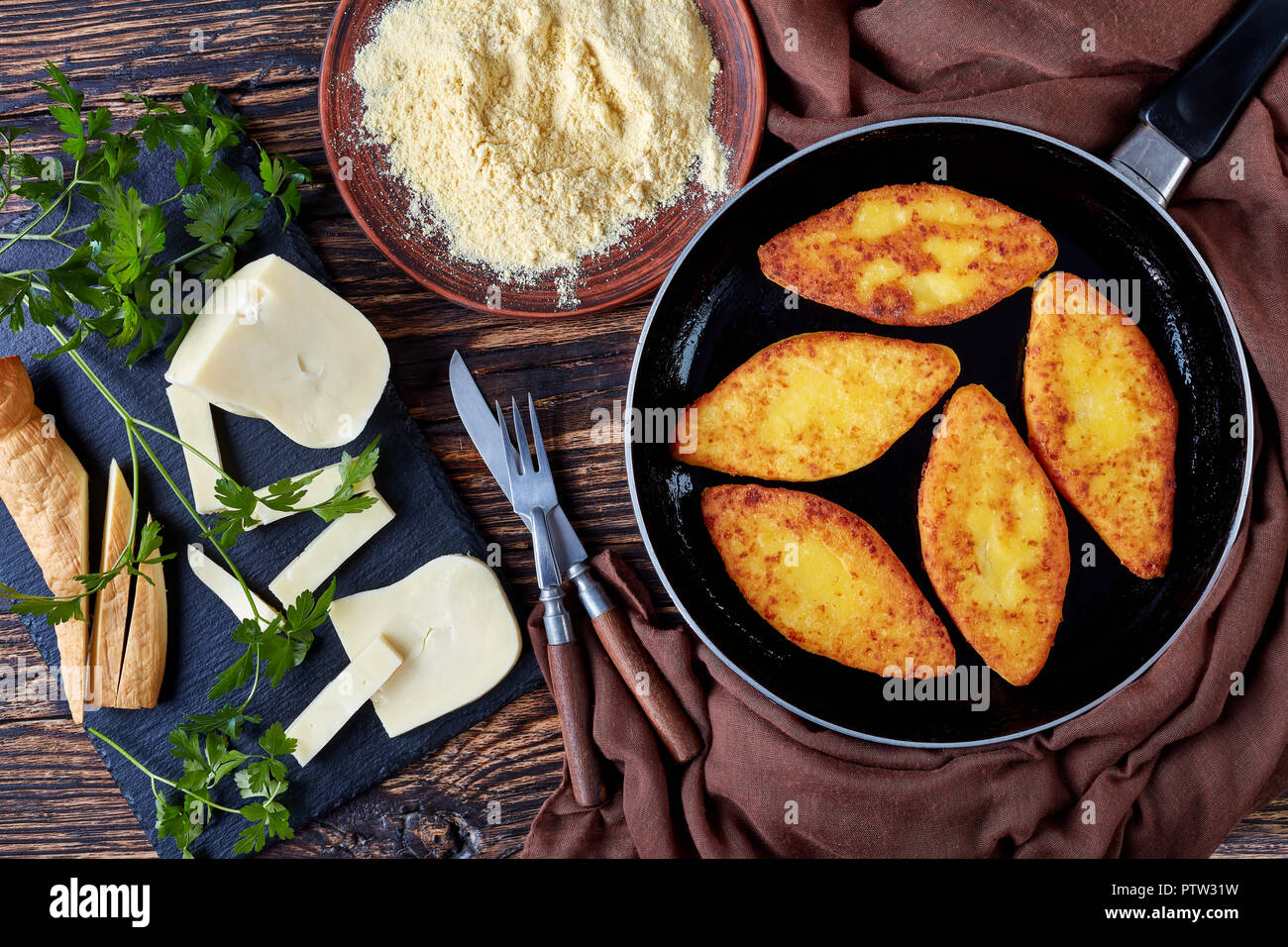 Chvishtari on a skillet with ingredients on the background - cornmeal, sulguni cheese, view from above, flat lay Stock Photo