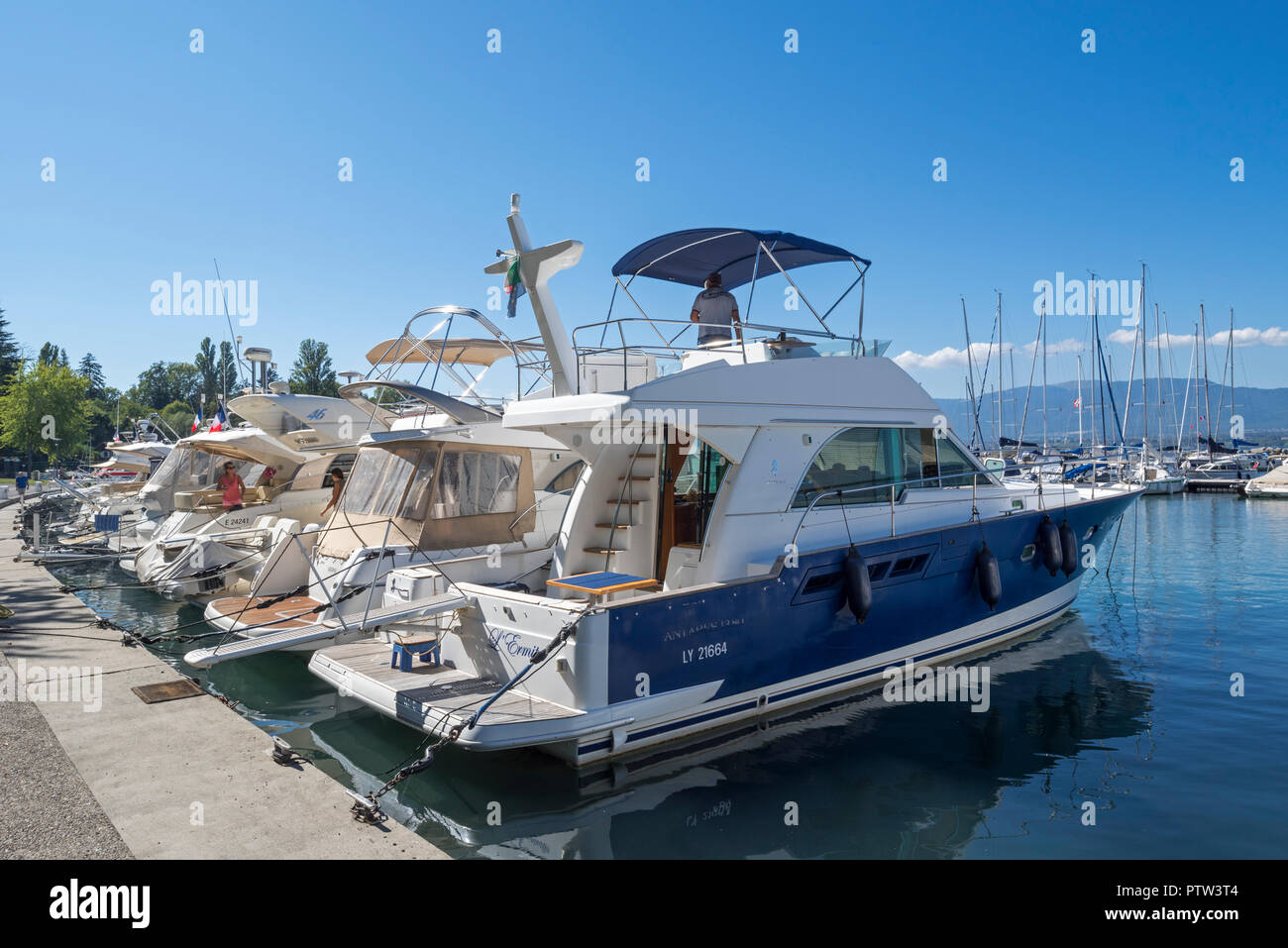 Luxury motorboats, sailing boats and yachts moored in the marina at Yvoire along Lake Geneva / lac Léman, Haute-Savoie, France Stock Photo