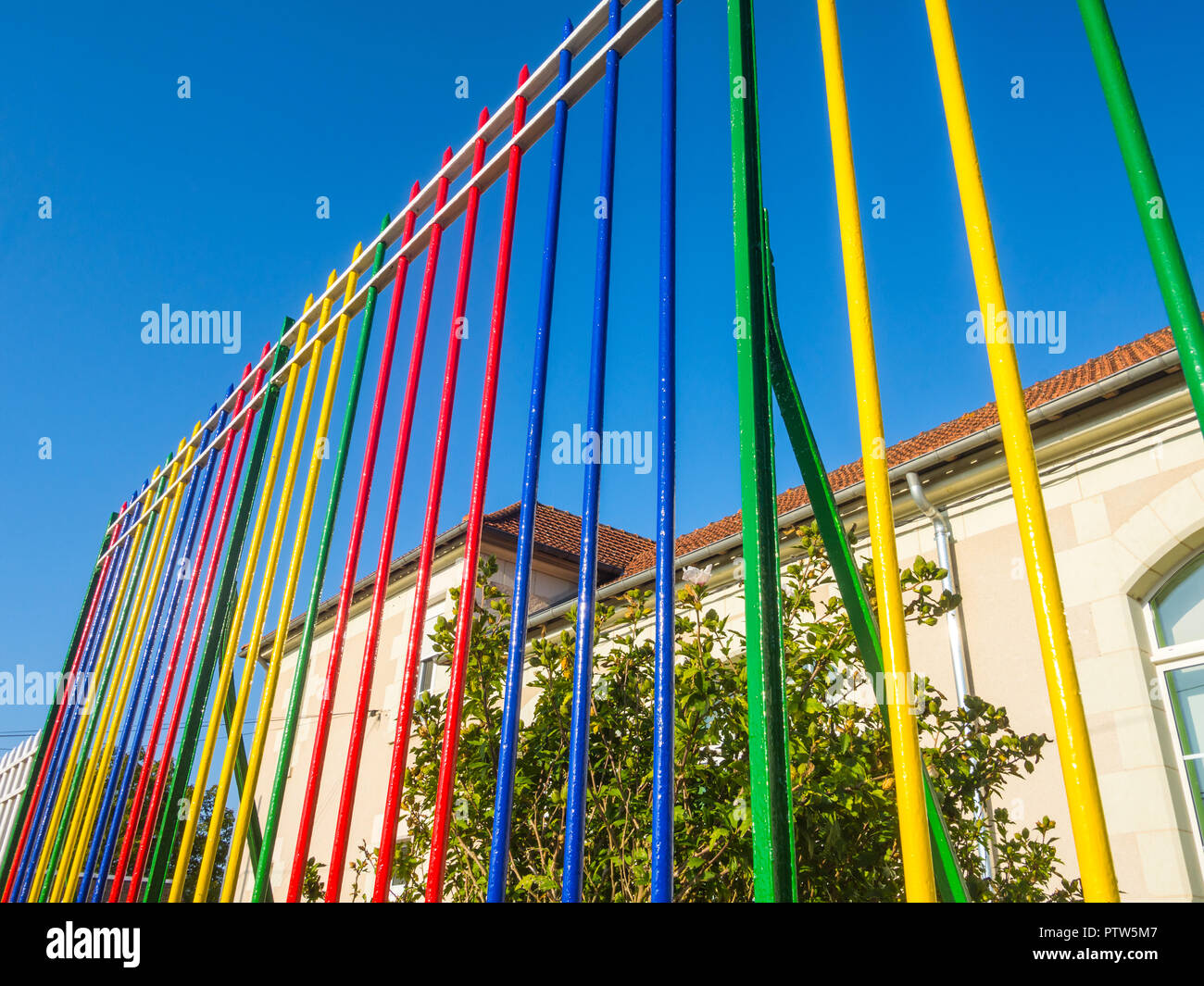 Painted fencing outside French primary school. Stock Photo
