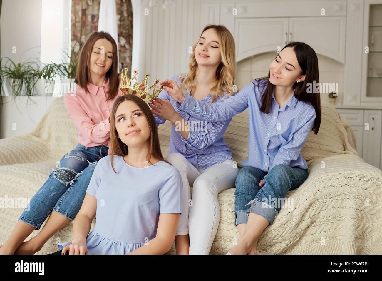 Girlfriends meeting friends talking in the room.  Stock Photo