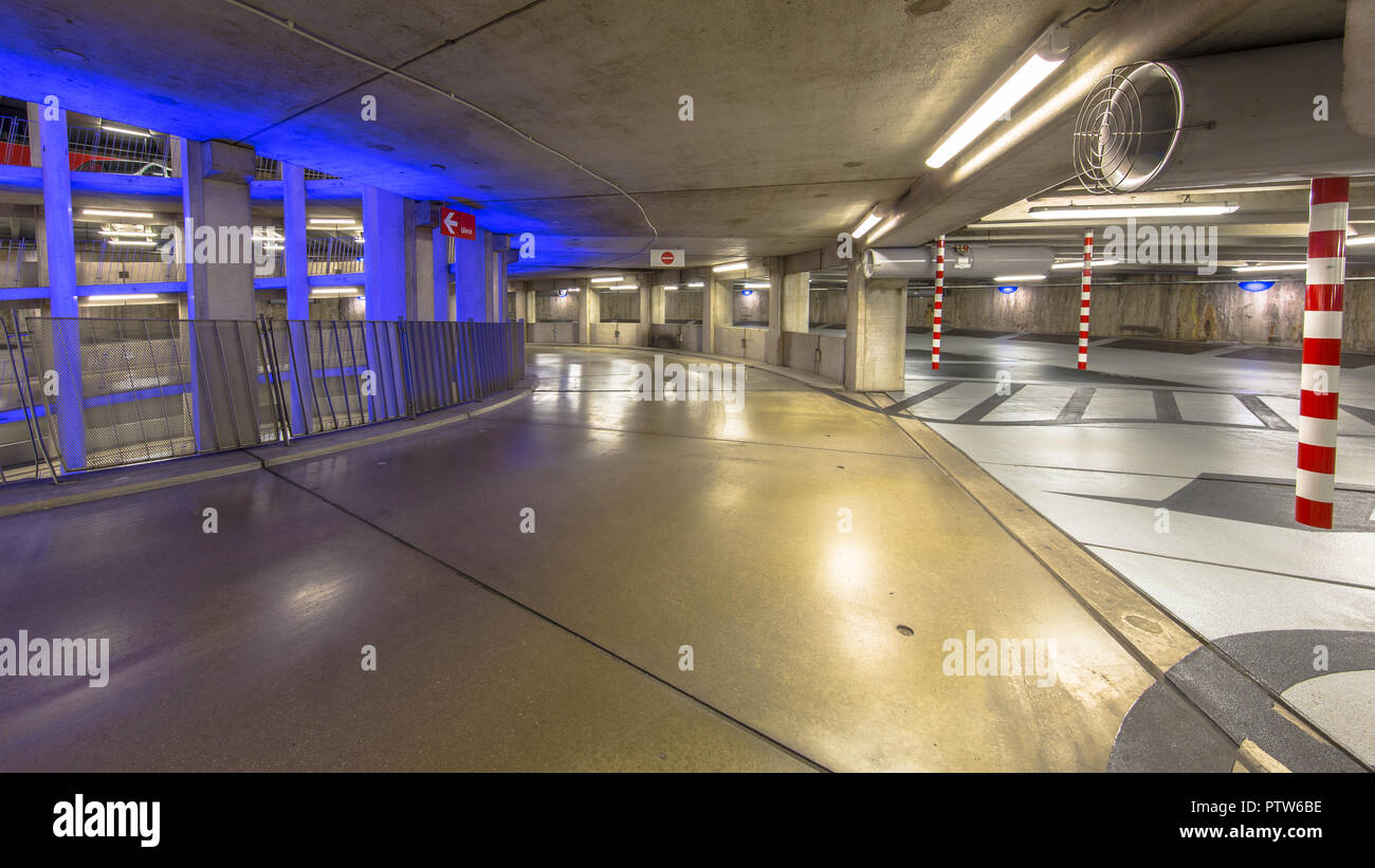 Empty Driveway in circular underground parking garage with colorful lighting under a soccer stadium Stock Photo