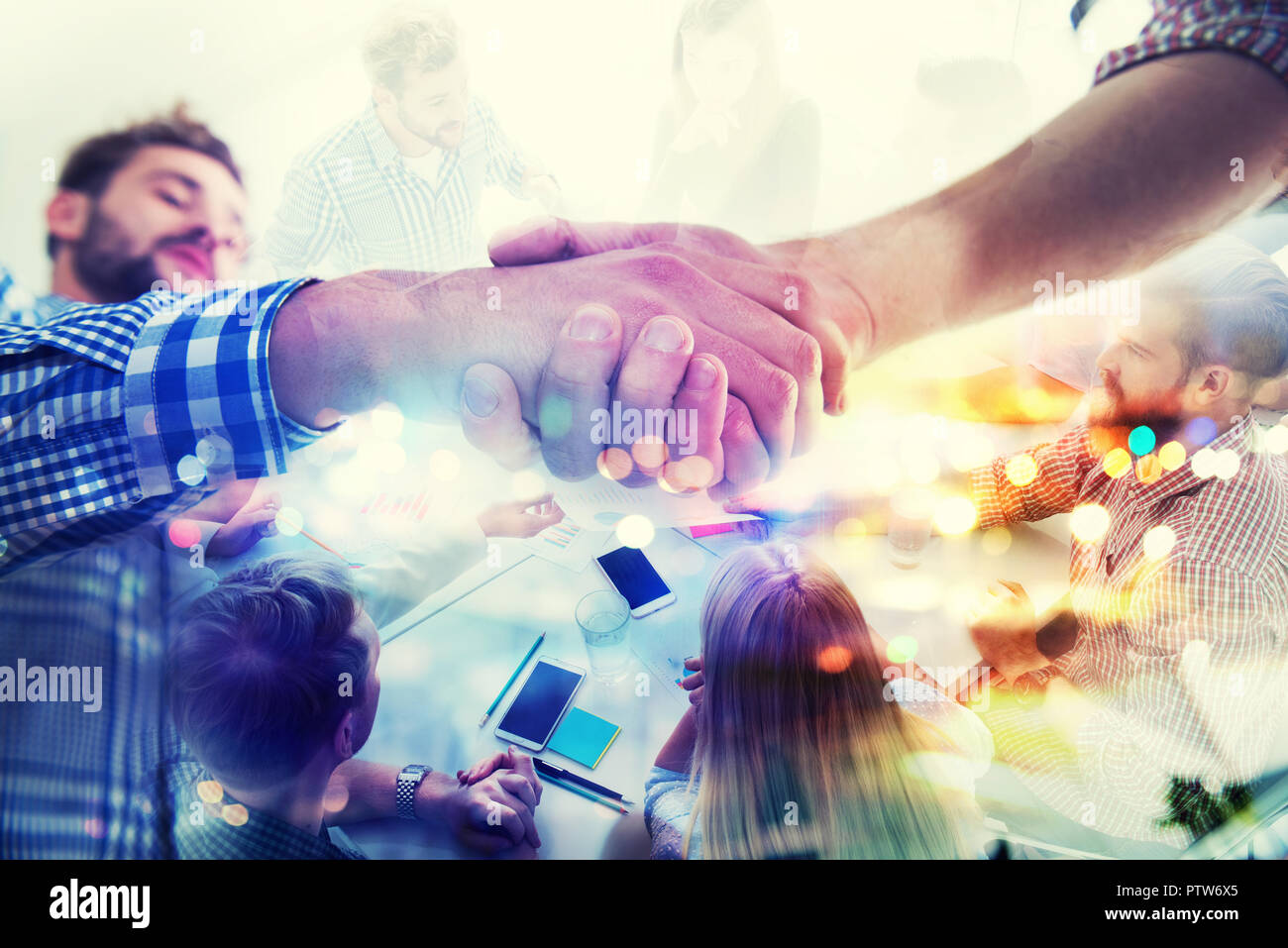 Handshaking business person in casual wear in the office. concept of teamwork and partnership. double exposure Stock Photo